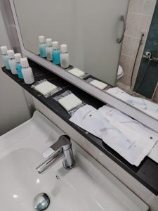 a bathroom counter with a sink and a mirror at Pera Hotel Baku in Baku