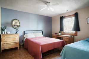 a bedroom with two beds and a ceiling fan at Hot Tub, River&Kayak, WiFi, & Fire Pit at Cabin! in Morton Grove
