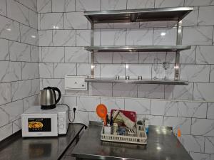 a kitchen with a counter top with a microwave at Perfecthotel in Myrhorod