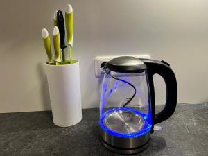 a black electric kettle and a cup of utensils at Apartment Eiler - Mellau in Mellau