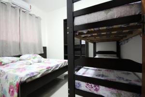 a bedroom with two bunk beds and a bed at Casa Novo in Olímpia