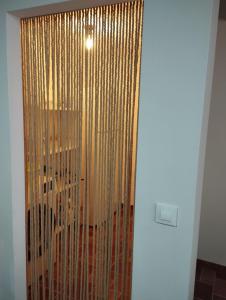 a sliding glass door with gold curtains in a room at Vivienda Rural Ronda in Aldeaquemada +13 photos