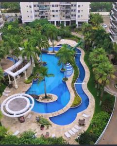an aerial view of a resort pool with palm trees at Barra Family Resort, a sua melhor escolha in Rio de Janeiro