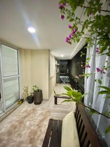 a living room with a bench and some plants at Barra Family Resort, a sua melhor escolha in Rio de Janeiro