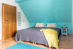 um quarto com uma cama com uma parede azul em Zum Heidegarten em Winterberg