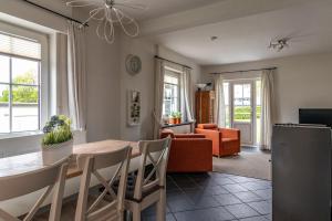 a dining room and living room with a table and chairs at Zum Heidegarten in Winterberg