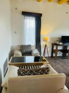 a living room with a couch and a table at Guza Ethnic Resort in Leh