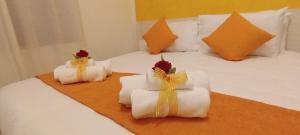 a bed with white towels and flowers on it at G&G Giusy e Gabry in Santhià