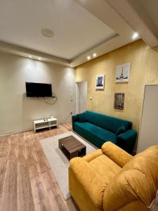 a living room with a couch and a tv at Private Apartment Zamalek in Cairo