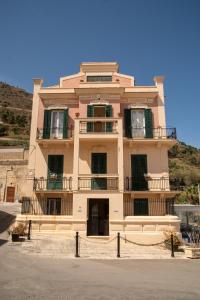 a large building with balconies on top of it at Liberty house in Castellammare del Golfo