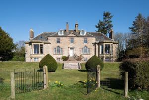 an old house with a gate in front of it at Cairnbank House in Duns