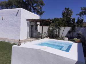 a swimming pool in front of a white house at TAPAYIA in Chiclana de la Frontera