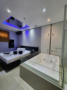 a large bathroom with a tub and a bed at Motel Só Love 4 in Sao Paulo