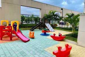 a playground with colorful play equipment in a courtyard at 0406 - Studio Refúgio Cidade Maia in Guarulhos