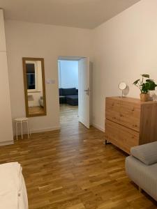 a living room with a dresser and a mirror at Apartament Otwarta Wrocław in Wrocław