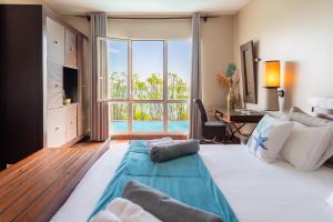 Una cama o camas en una habitación de Emeraude Villas - Lagon