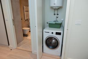 a laundry room with a washing machine and a toilet at Studio Passion - Belgrade Waterfront in Belgrade
