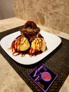 a plate with three desserts on a table at Motel Só Love 4 in Sao Paulo +10 photos