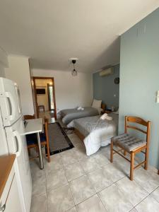 a room with a bedroom with a bed and a desk at Flo's Apartments in Mesolongion +2 photos