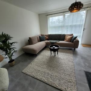a living room with a couch and a table at Ecolodges De Dreef Guesthouse in Renesse