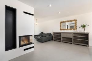 a living room with a fireplace and a couch at Luxury Apartments Villa San Avia in Banjole