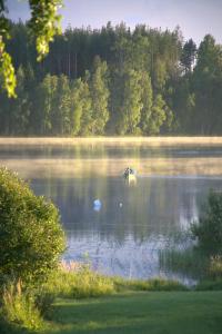 Un lago con un barco en medio. en Country house Ruohoranta en Kuopio