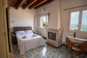 a bedroom with a bed and a fireplace at Liberty house in Castellammare del Golfo