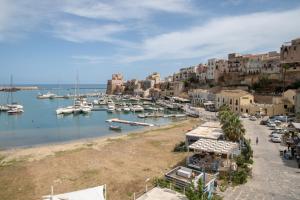 a harbor with boats in the water and buildings at Liberty house in Castellammare del Golfo