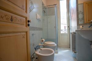 a bathroom with a toilet and a sink at Liberty house in Castellammare del Golfo