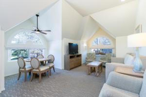 a living room with a couch and a table at Wave Crest Resort in San Diego