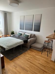 a bedroom with a bed and a couch at Marina Primore Apt nad morzem in Gdańsk