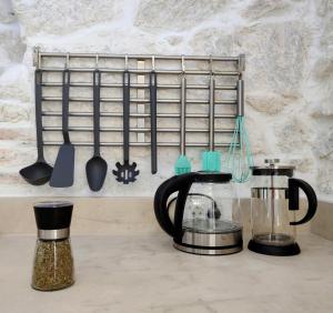 a kitchen counter with a coffee maker and utensils at NEBOKRAJ in Kraj