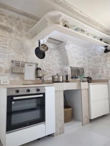 a white kitchen with a stove and a sink at NEBOKRAJ in Kraj