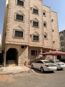 two cars parked in front of a building at Hanan petra House 