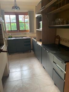 een keuken met een spoelbak en een aanrechtblad bij Apartamento no centro de Gramado in Gramado +10 foto's
