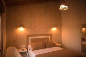 a bedroom with a bed with two pillows on it at La Casina de Palacio in Galisteo