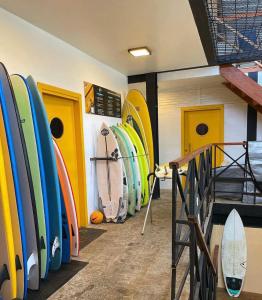 a bunch of surfboards are lined up in a room at Laika Hostel in Camburi