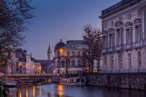 a city with buildings and a river with boats at Breathtaking Views in heart of Ghent in Ghent