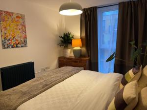 a bedroom with a large bed and a window at Lombok Apartment near Old Street,Islington,Angel in London