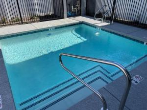 a swimming pool with a hand rail in a building at Modern Townhome in Arcadia ~ Pool & Private Yard in Phoenix