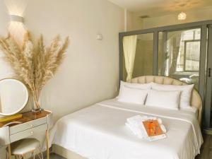 a bedroom with a bed with a mirror and a book at 6EVEN Nguyen Hue in Ho Chi Minh City