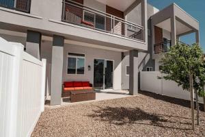 a house with a red couch on a balcony at Modern Townhome in Arcadia ~ Pool & Private Yard in Phoenix