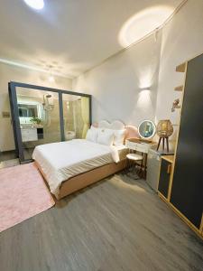 a bedroom with a bed and a desk with a mirror at 6EVEN Nguyen Hue in Ho Chi Minh City