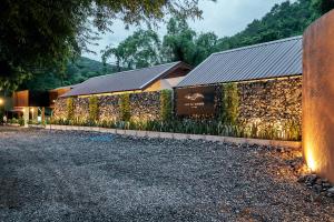 a building with a wall with plants on it at Baan Rai Santisuk in Ban Sok Dua