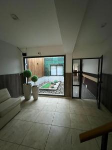 ein Wohnzimmer mit Couch und Topfpflanzen in der Unterkunft Rivadavia Departamentos in Mendoza + 5 Fotos