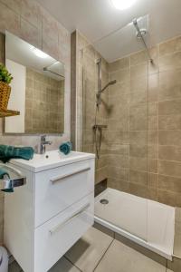 a bathroom with a white sink and a shower at Studio Victoria in Aix-les-Bains