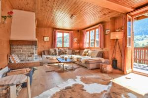 a living room with a couch and a fireplace at Chalet Castellani Duplex in Fiesch