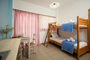 a small room with a bunk bed and a desk at Kalami apartment in Falasarna in Falasarna