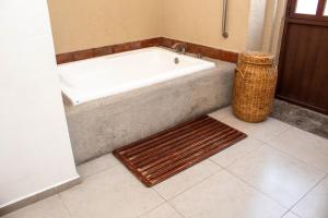 a bath tub sitting in a bathroom with a rug at Casa Pepe in Puebla