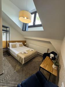 a small bedroom with a bed and a window at IRIS Aparthotel in Krakow